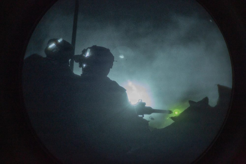 Soldier acquiring target through night scope